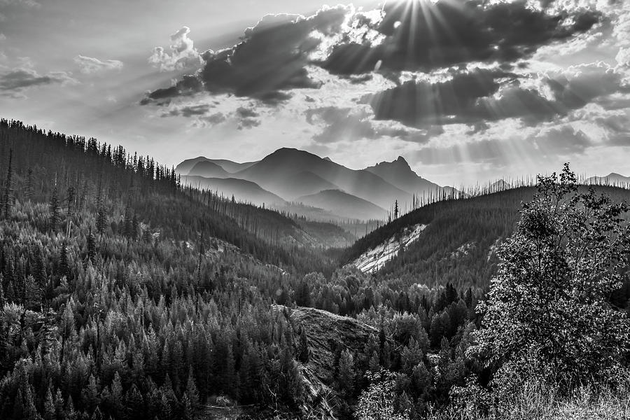 Black And White Photograph - Rays Of Light Over Glacier National Park Mountains - Black and White by Gregory Ballos