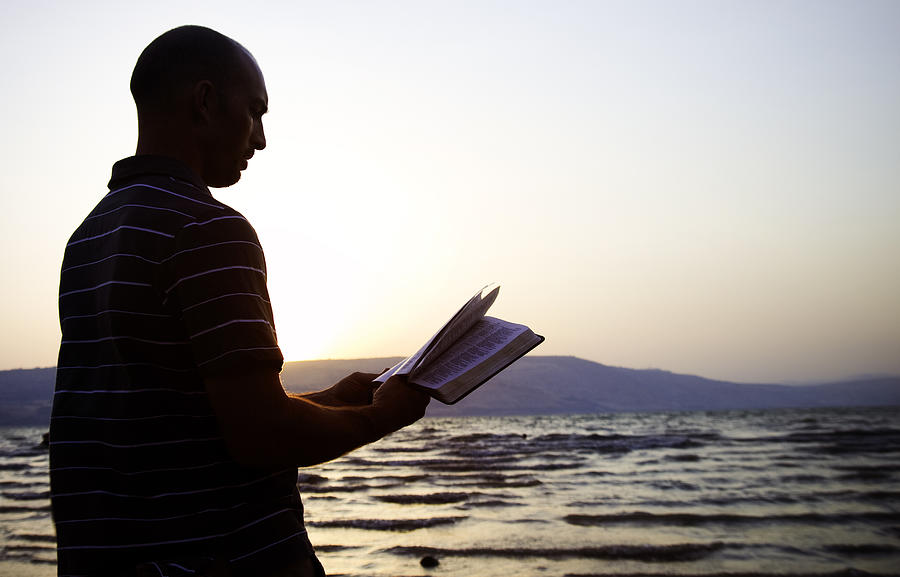 Reading the Bible by Sea of Galilee, Israel Photograph by RyanJLane