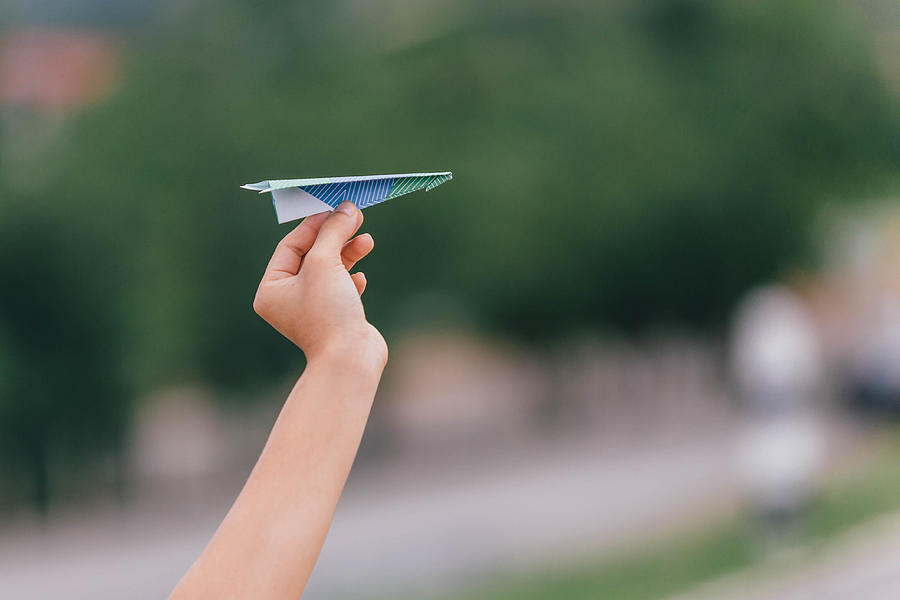 Ready to Fly Colorful Paper Plane with Your Hand Photograph by Artit_Wongpradu