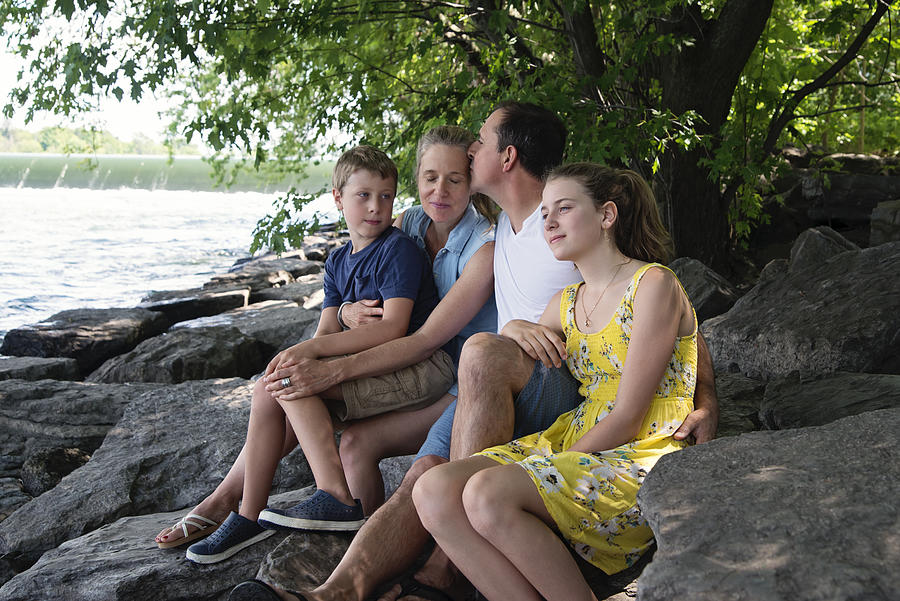 Real family portrait of 4 on riverside in summer. Photograph by Martinedoucet