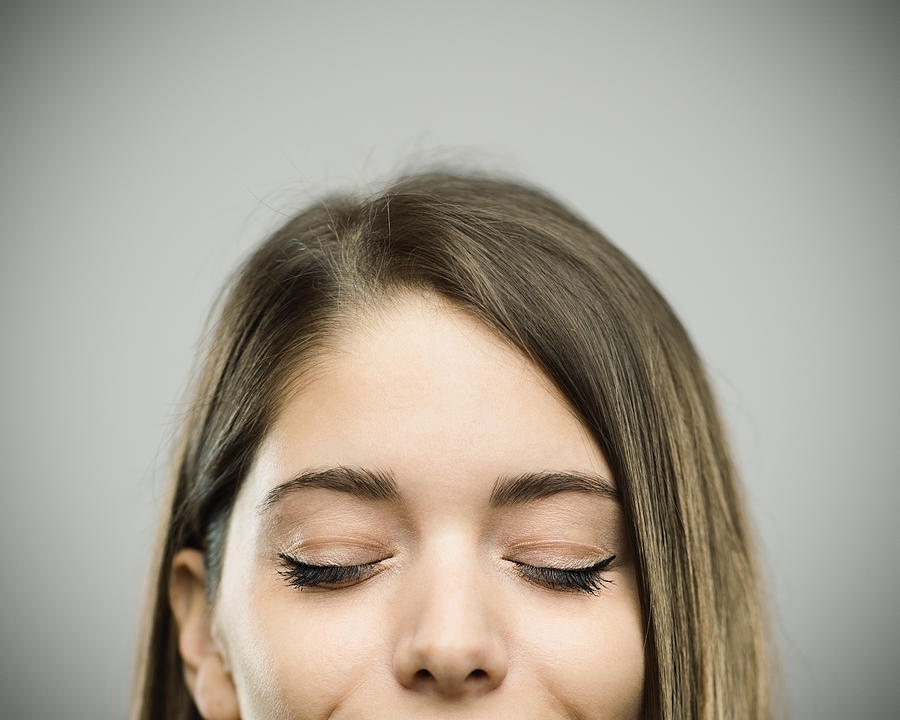 Real happy young woman studio portrait with closed eyes Photograph by SensorSpot