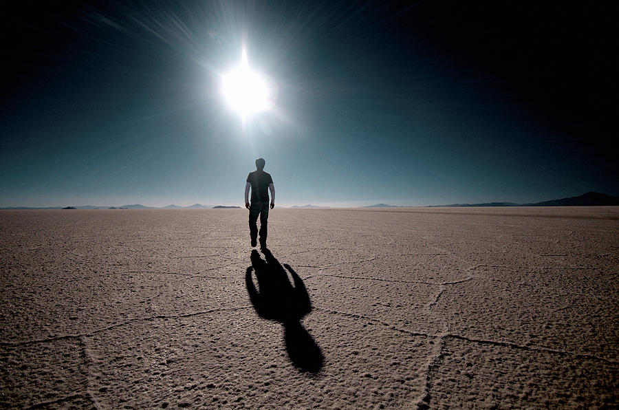 Rear view of a man walking on a salt flat, Salar De Uyuni, Bolivia Photograph by Hans Neleman