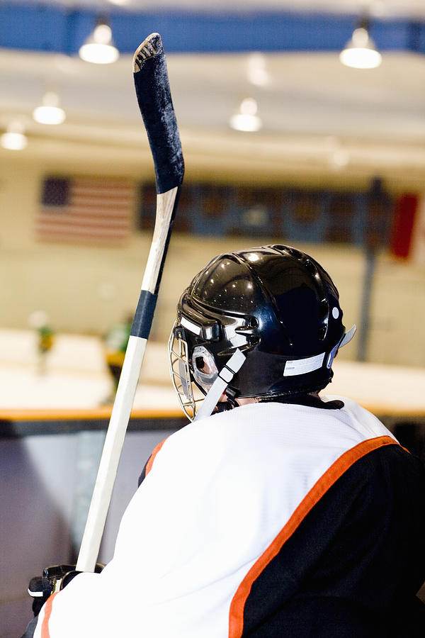Rear view of an ice hockey player near an ice rink Photograph by Glowimages