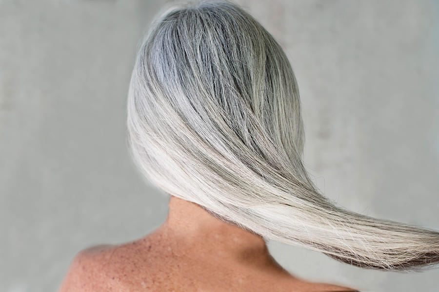 Rear view of bare shouldered mature woman with long grey hair Photograph by Gary John Norman