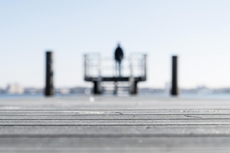 Rear view of man standing on a pier at the coast in Kiel (Germany) Photograph by Tina Terras & Michael Walter