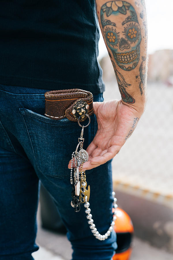 Rear view of man with keys in back pocket and skull tattoo, cropped Photograph by Eugenio Marongiu