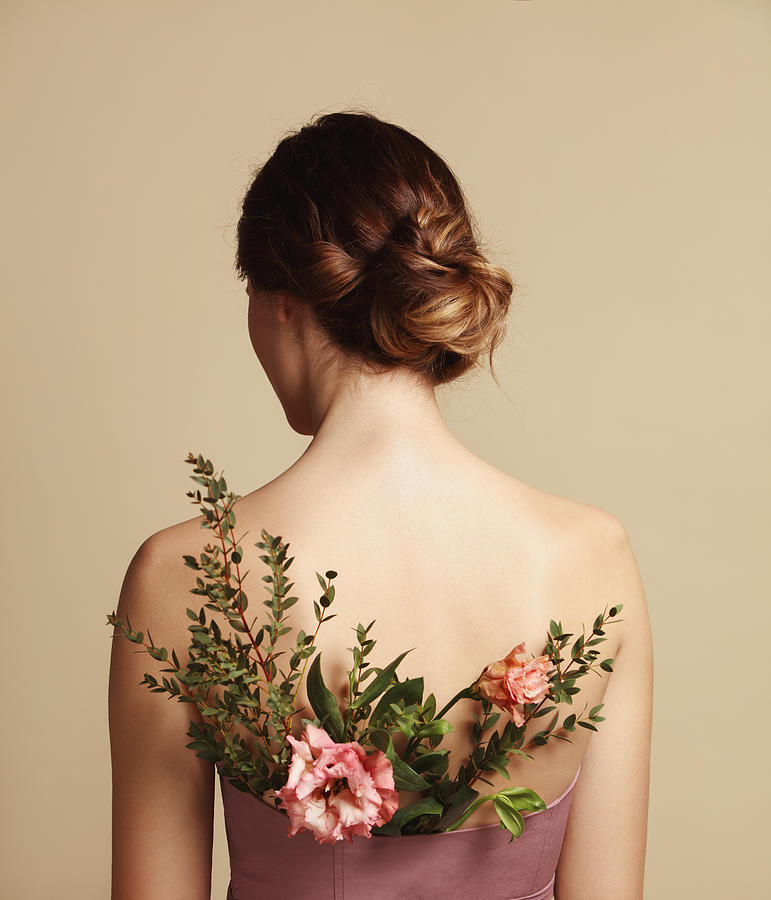 Rear view of young woman and flowers Photograph by Lambada
