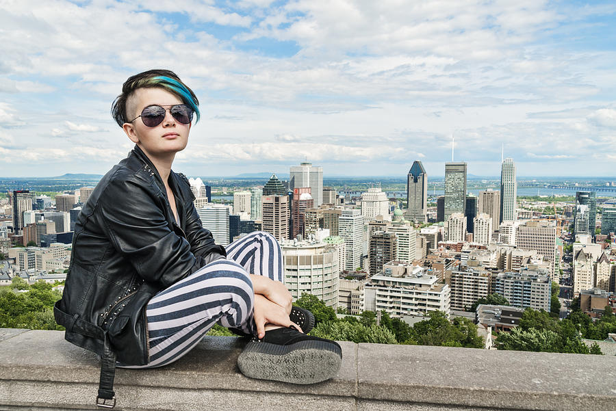 Rebel androgynous teenager in front of Montreal cityscape. Photograph by Martinedoucet