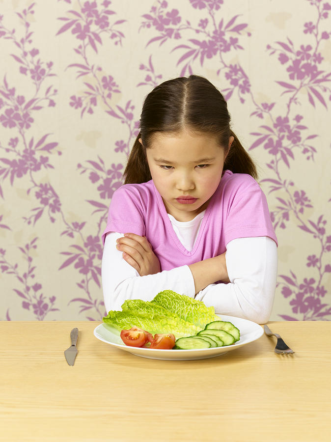 Rebellious child refusing to eat salad. Photograph by Peter Dazeley