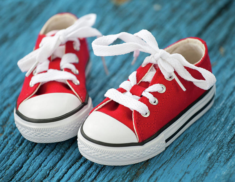 Red Baby Sneakers On Wooden Blue Background Photograph