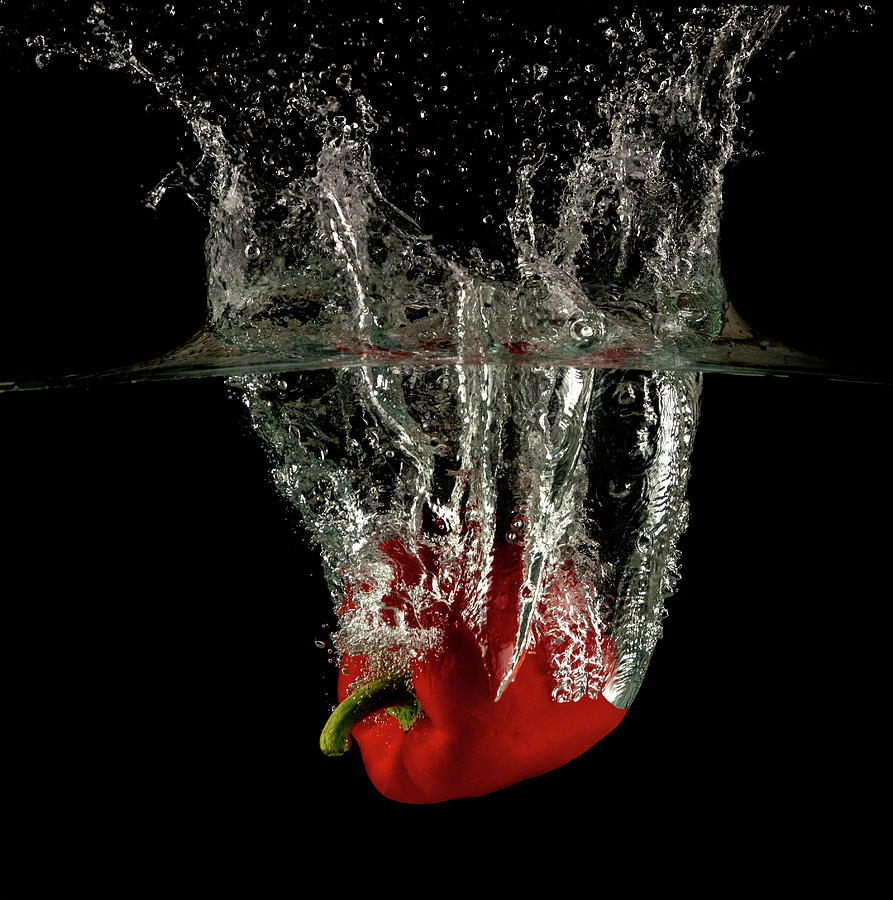 Red bell pepper dropped and slashing on water Photograph by Michalakis Ppalis