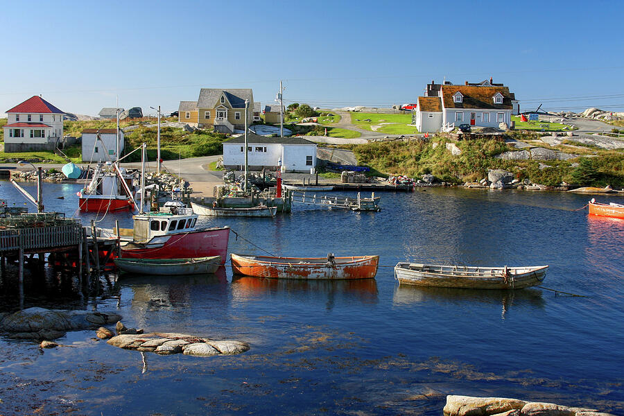Red boats in Peggys Cove Nova Scotia Photograph by Tatiana Travelways
