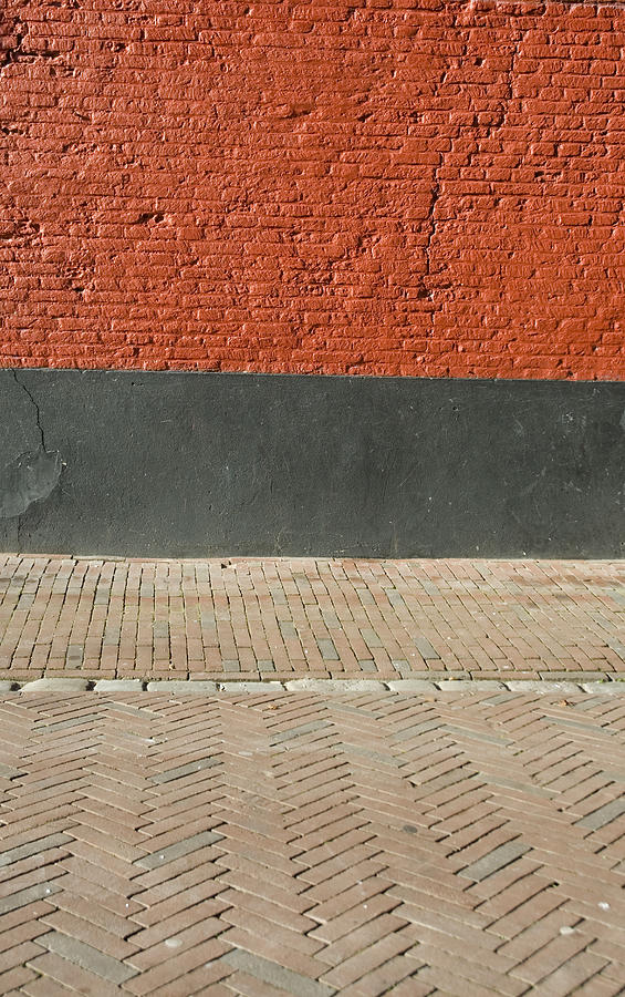 Red brick wall and paved street Photograph by Lyn Holly Coorg