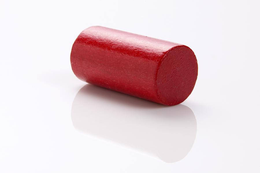 Red building block, cylinder, close-up Photograph by Tom Hoenig