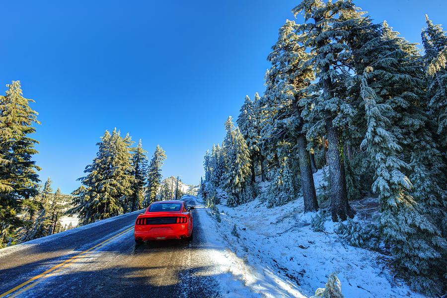 Red car on snowy and icy winter road Photograph by Aiisha5