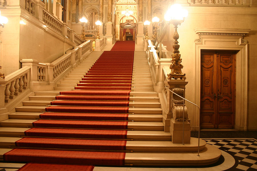 Red carpet cascading down a grand staircase Photograph by Trait2lumiere