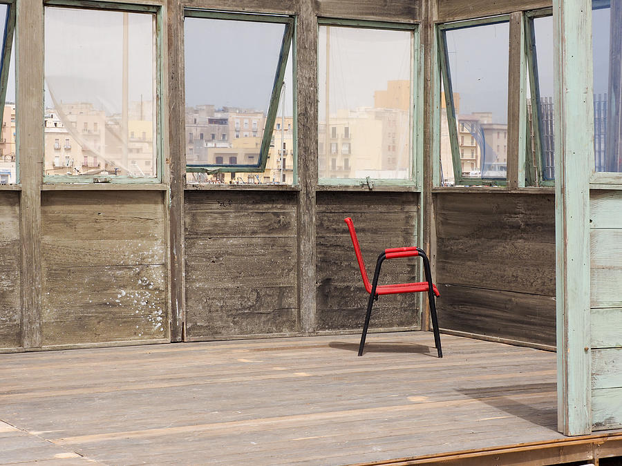 Red chair in wooden building Photograph by Lysvik Photos