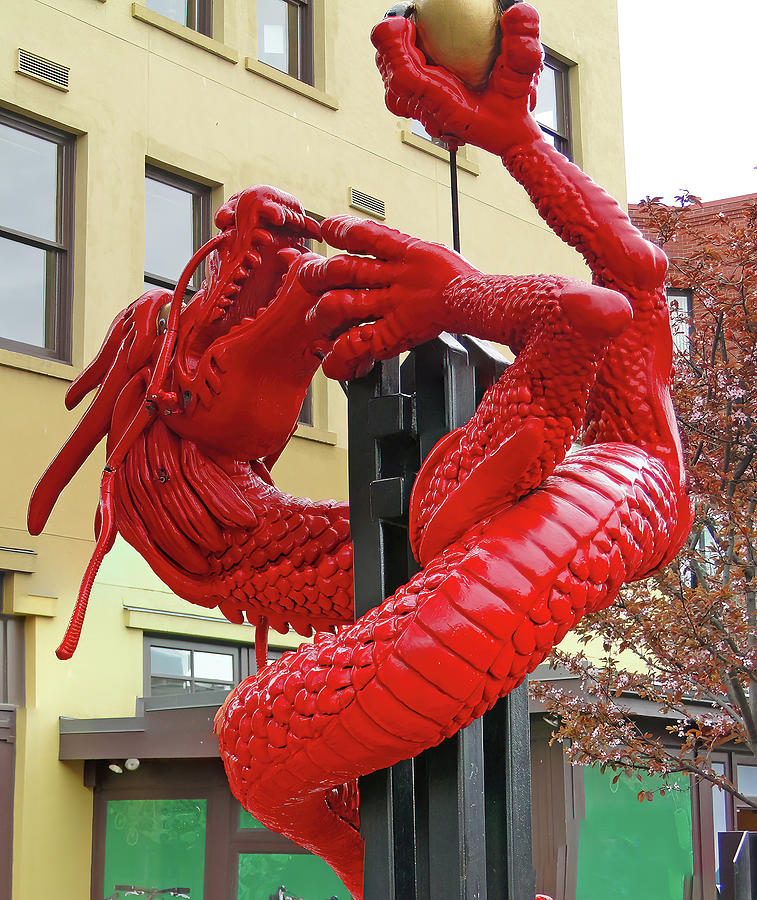 Red dragon climbs a street lamp Photograph by Steve Estvanik
