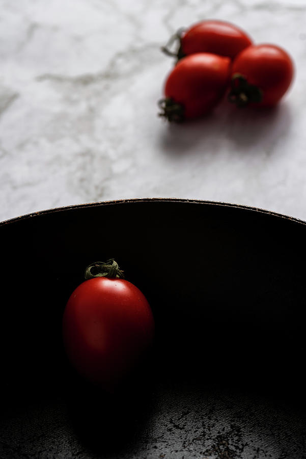 Red fresh healthy tomatoes isolated on a black pan Photograph by Michalakis Ppalis