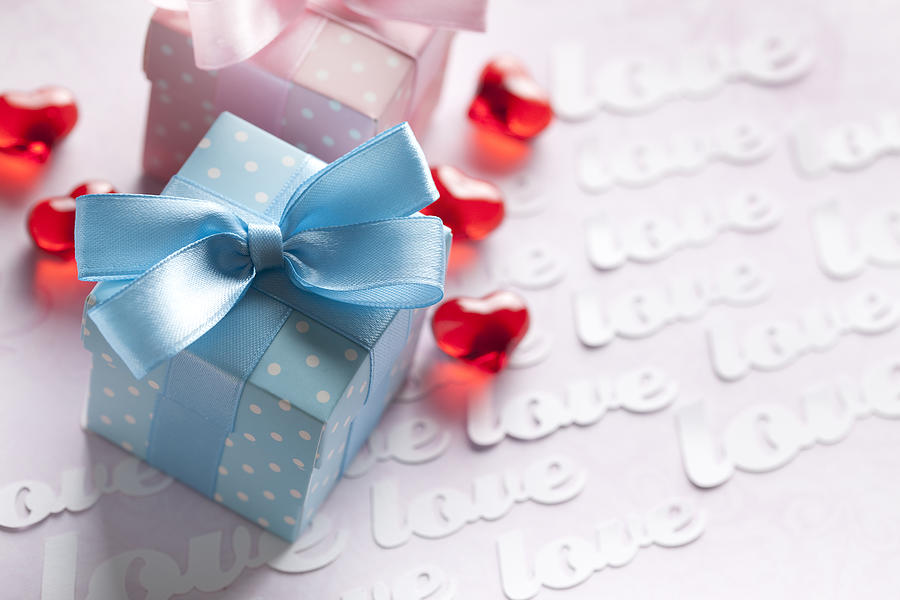 Red hearts and gift boxes on pink background Photograph by Tedestudio