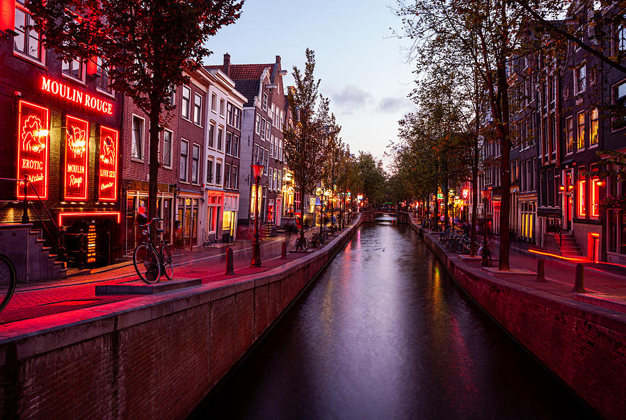 Red light district along Oudezijds Achterburgwal street in Amsterdamn Netherlands at dusk/sunset. Photograph by Jjwithers
