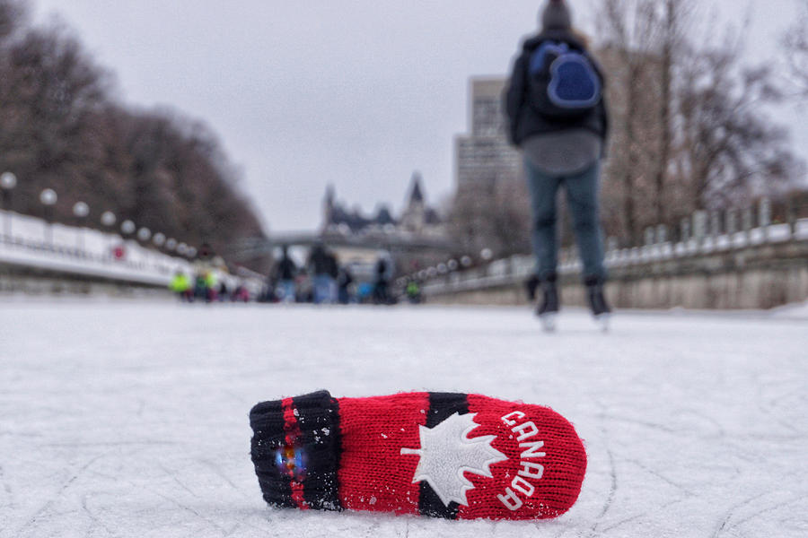 Red mitt and the winter view of the Rideau Canal Skateway in Ottawa during Winterlude 2019. The world’s longest skating rink is enjoyed by many skaters. Photograph by Jana Kriz