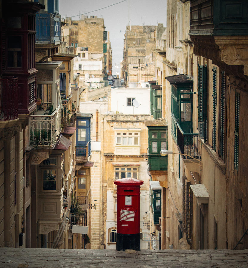 Red postbox in the middle of the street Photograph by Photo by Rafa Elias
