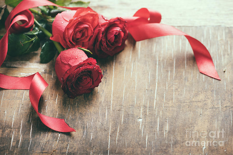 Red roses with red ribbon on wooden table Photograph by Jelena Jovanovic