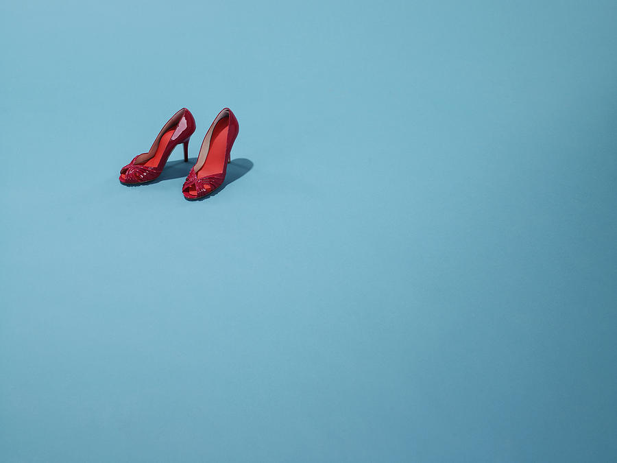 Red shoes sit on a blue backdrop Photograph by Michael Blann