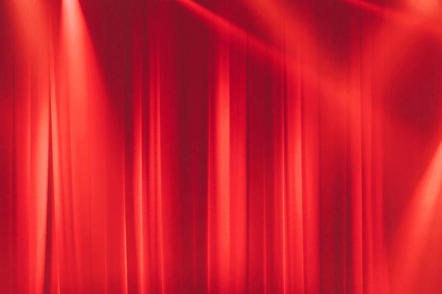 Red stage curtain in the spotlights with light rays Photograph by Laurent Sauvel