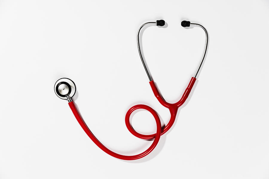 Red stethoscope on white background Photograph by Peter Stark
