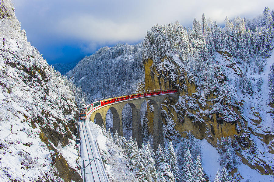 Red train in winter wonderland Photograph by © Marco Bottigelli