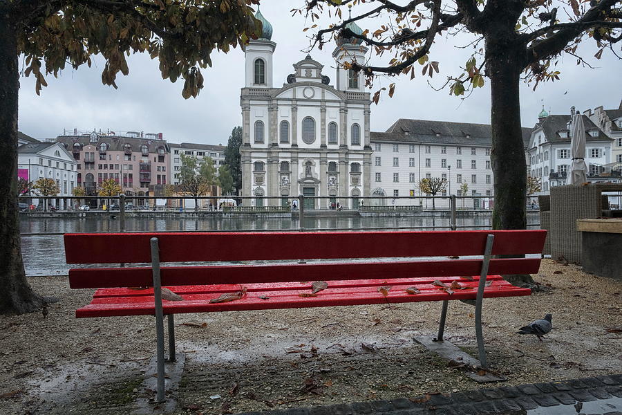 Red wet bench and Jesuit Church across Reuss river,Lucerne. Photograph by Emreturanphoto