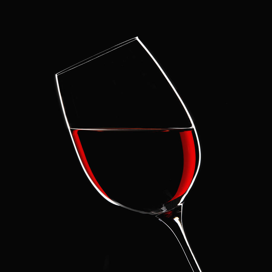 Red wine in glass indoors Photograph by Simon Murrell