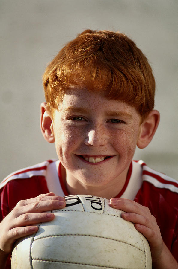 Redheaded Boy With Soccer Ball Photograph by Grant Faint