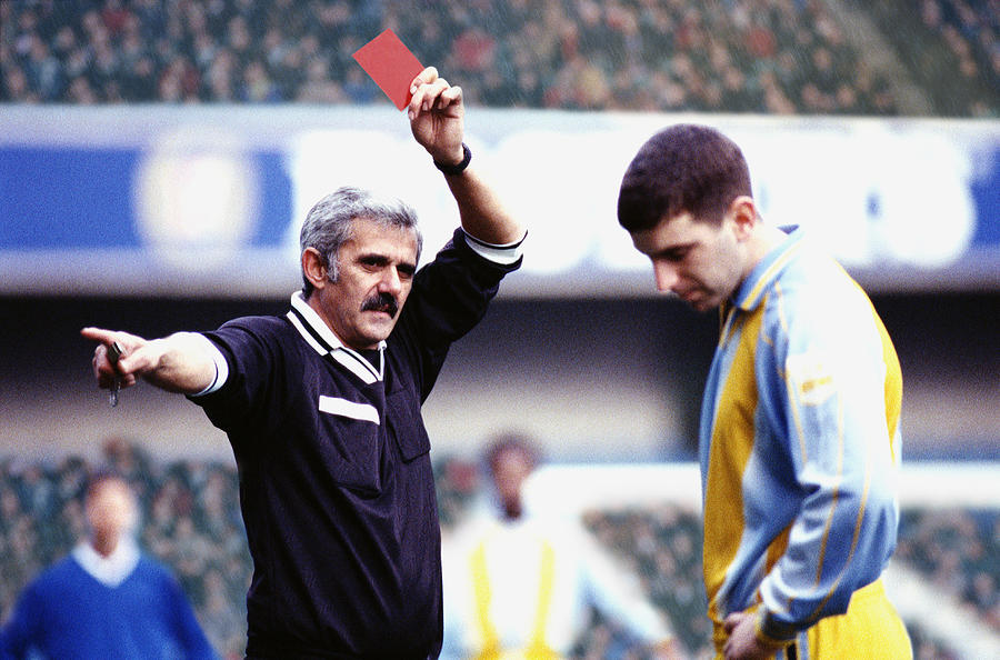 Referee giving a soccer player a red card Photograph by VCL/Chris Ryan