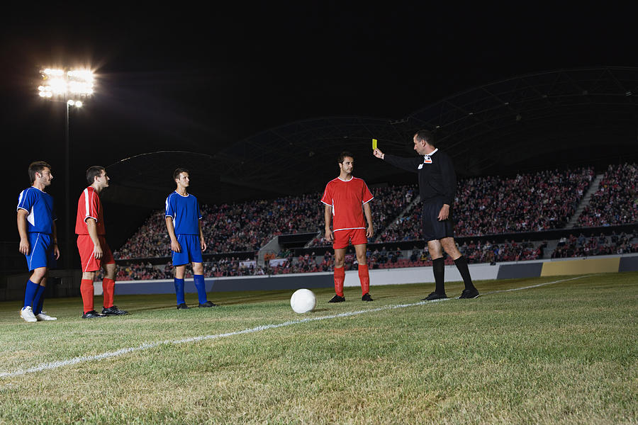 Referee giving yellow card Photograph by Image Source