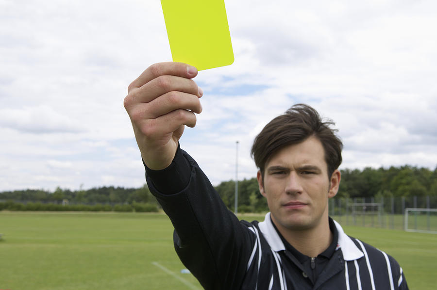 Referee showing yellow card Photograph by Stock4b-rf