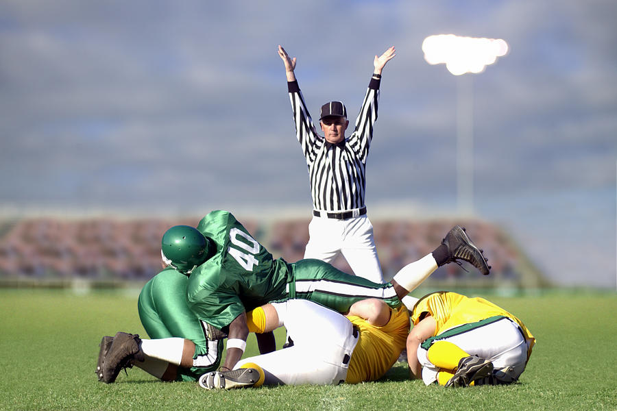 Referee signaling touchdown during football game Photograph by Thinkstock