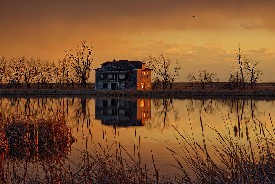 Reflecting on the Past -  Sunset at a flooded prairie farmhouse in ND near Churchs Ferry Photograph by Peter Herman