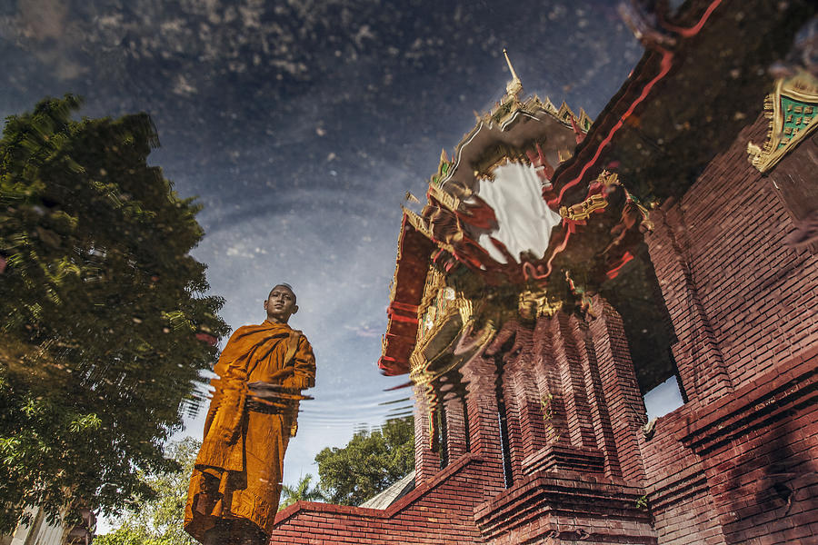 Reflection of Buddhist monk in water Photograph by David Trood