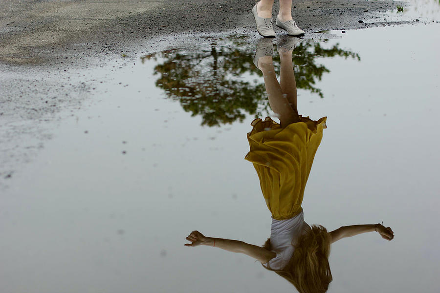 Reflection of girl dancing in puddle Photograph by Caiti Borruso