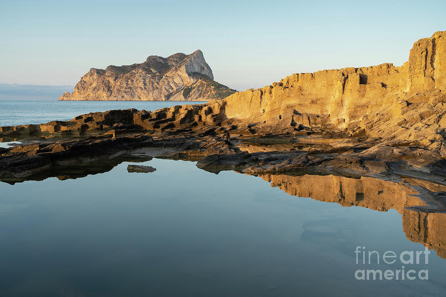 Reflection of rocks in the calm Mediterranean Sea at sunrise 2 Photograph by Adriana Mueller