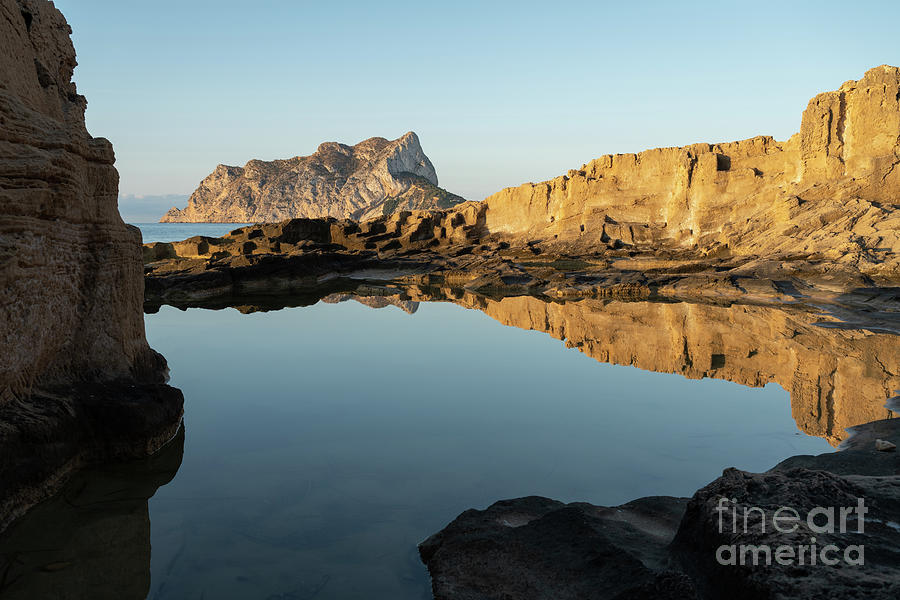 Reflection of rocks in the calm Mediterranean Sea at sunrise 3 Photograph by Adriana Mueller
