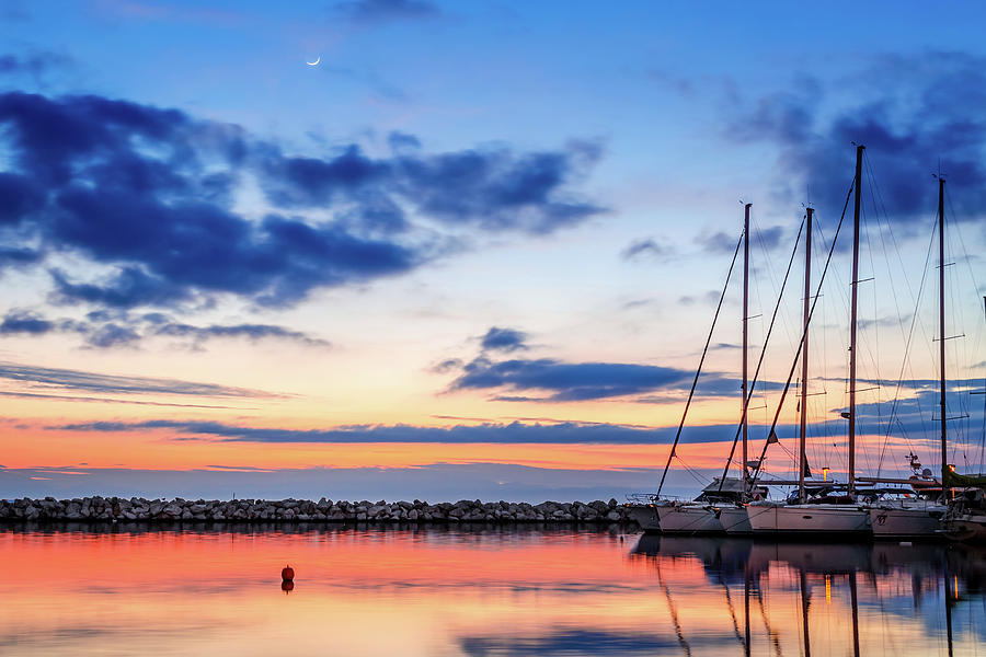 Reflection of sailboats at sunset in Kalamaria Photograph by Alexios Ntounas