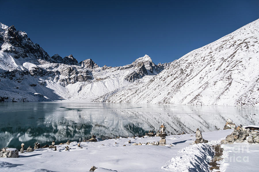 Reflection of the stunning Gokyo lake at 4800m in the Himalaya i Photograph by Didier Marti