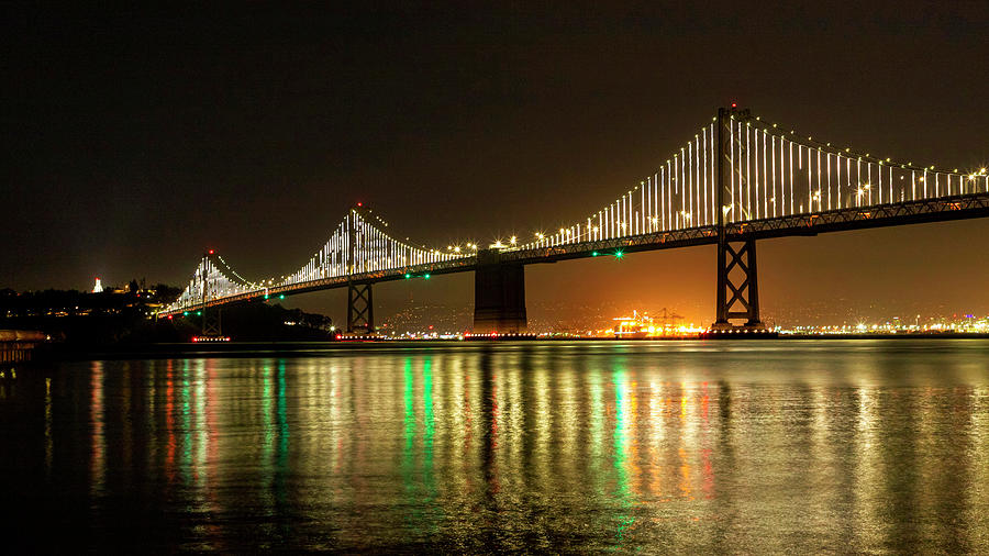 Reflections of the Bay Bridge Lights Photograph by Bonnie Follett