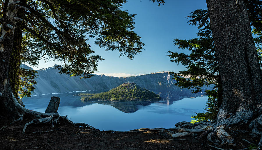 Reflective Blue Waters of Crater Lake between pine trees Photograph by ...