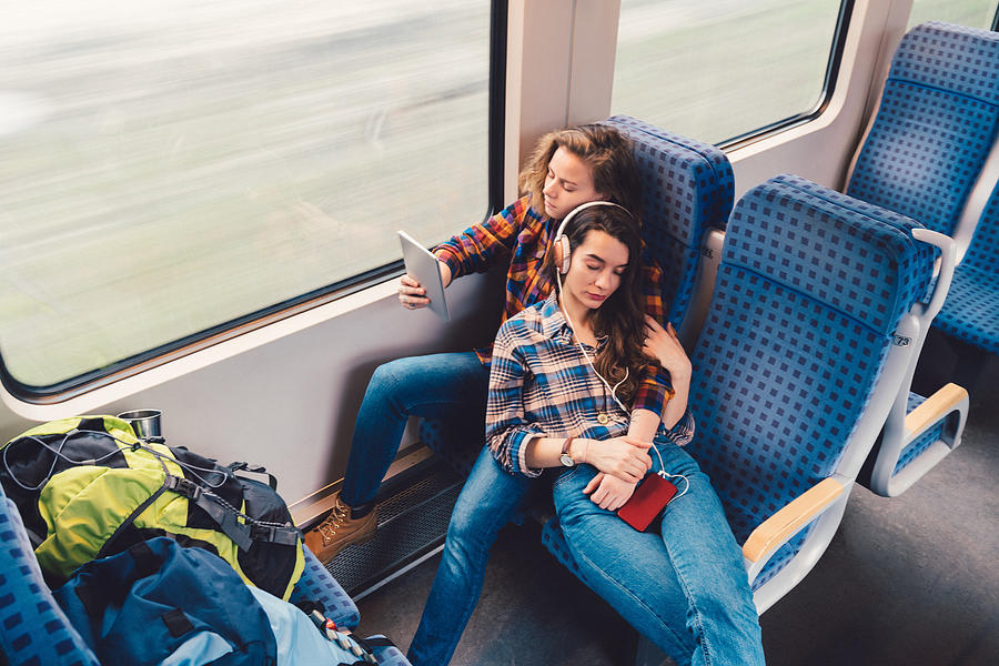 Relaxed couple traveling by train Photograph by Martin-dm