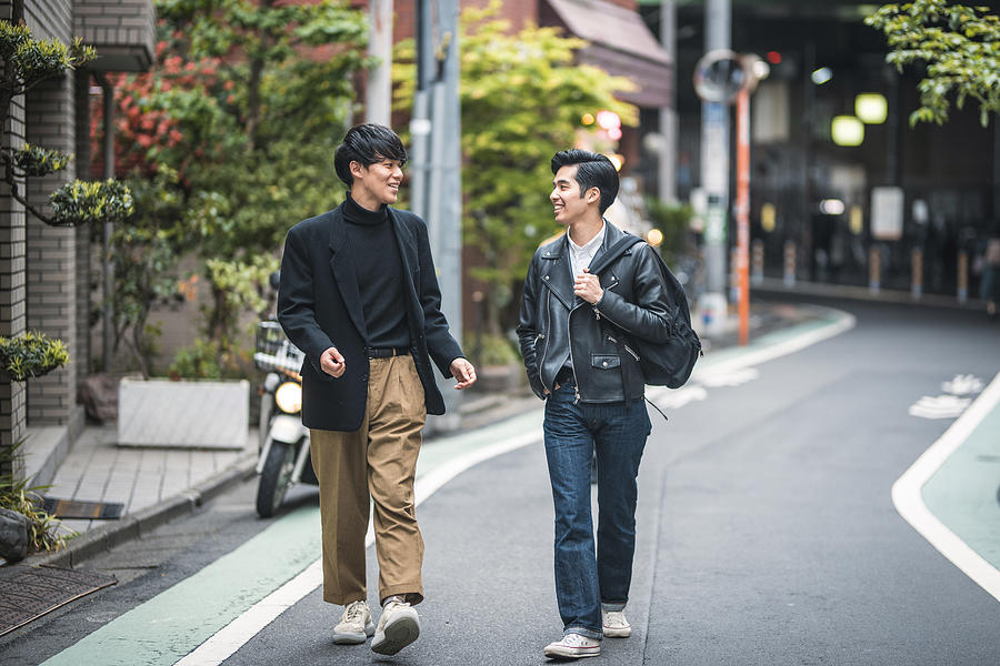 Relaxed Japanese Male Friends Walking and Talking in Tokyo Photograph by AzmanL